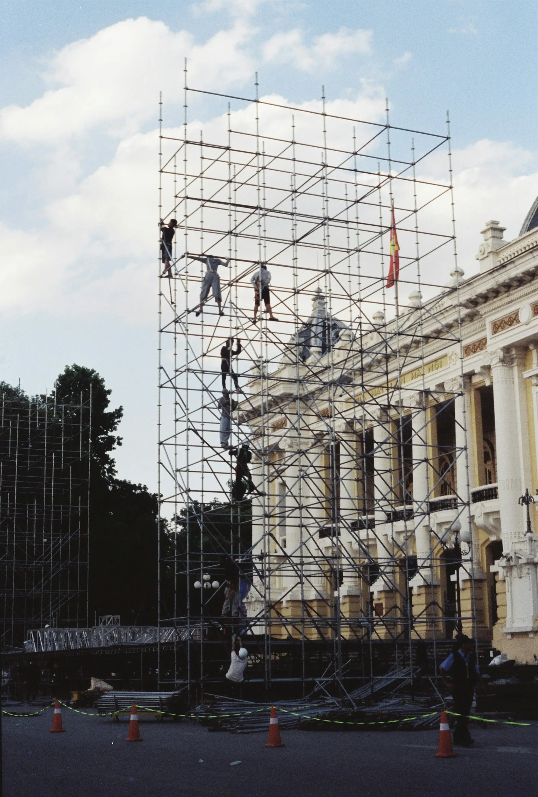 Scaffolders working on a tall scaffolding structure