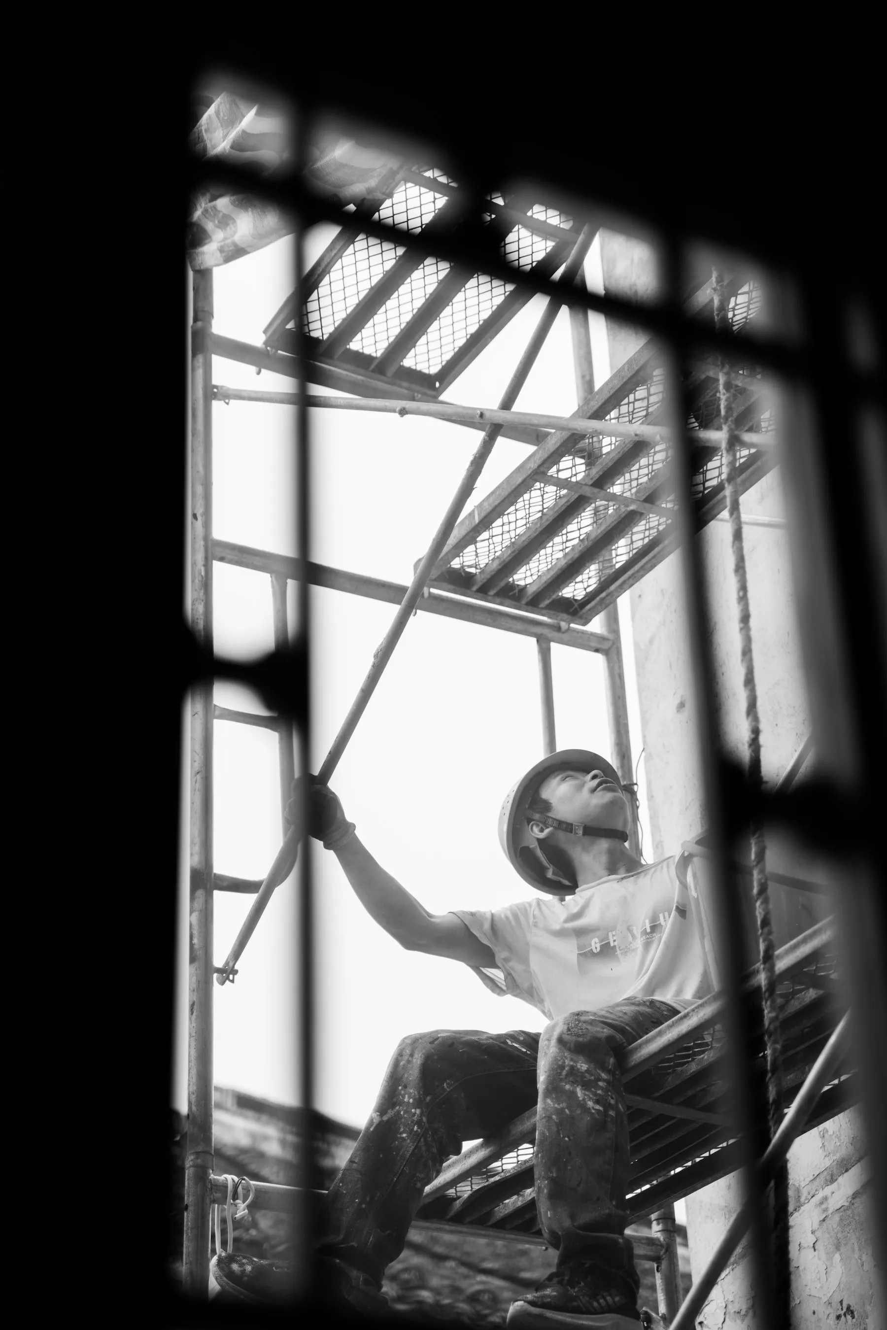 Worker climbing industrial scaffolding
