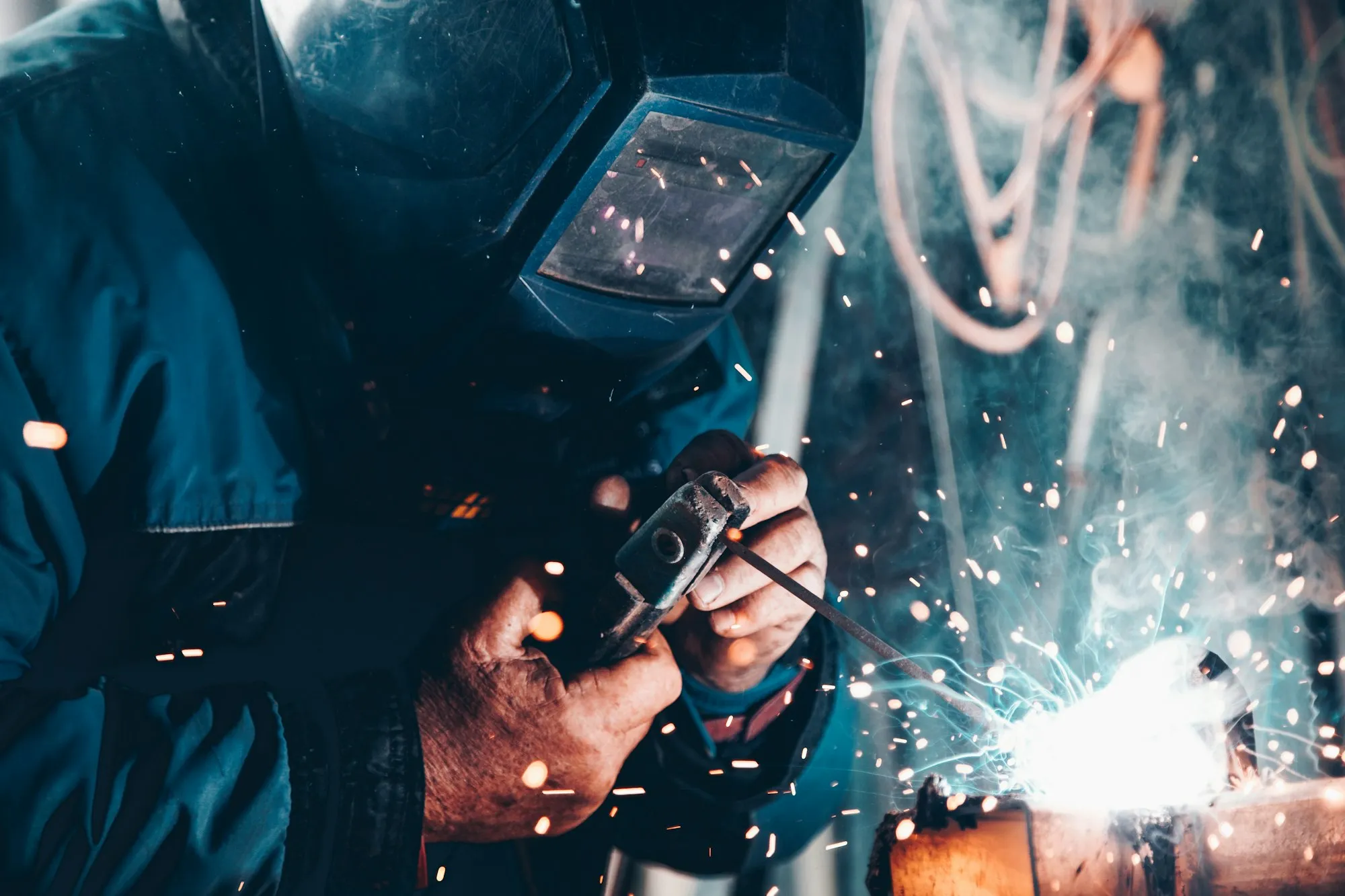 Welder working on metal sheeting and cladding